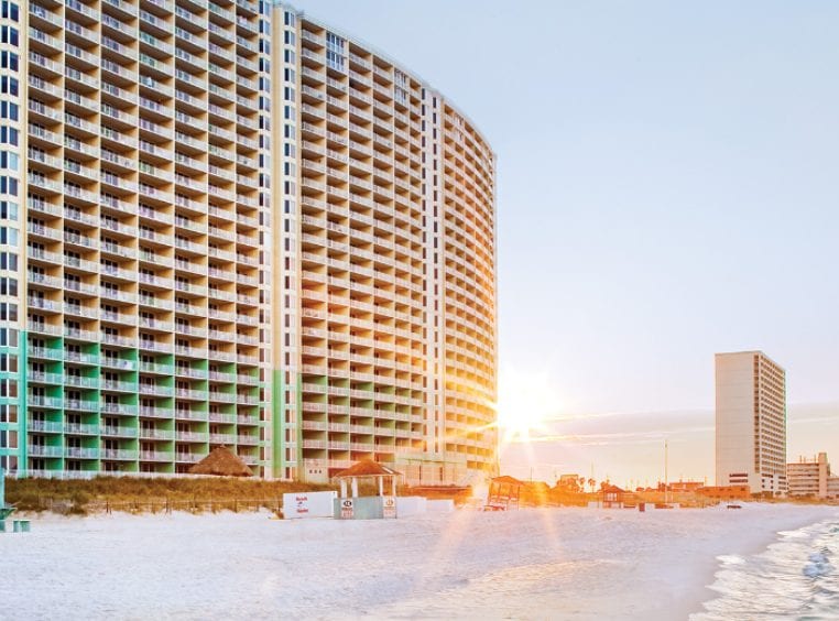 The exterior Club Wyndham Panama City Beach, an oceanfront timeshare resort in Panama City Beach, Florida at sunset.